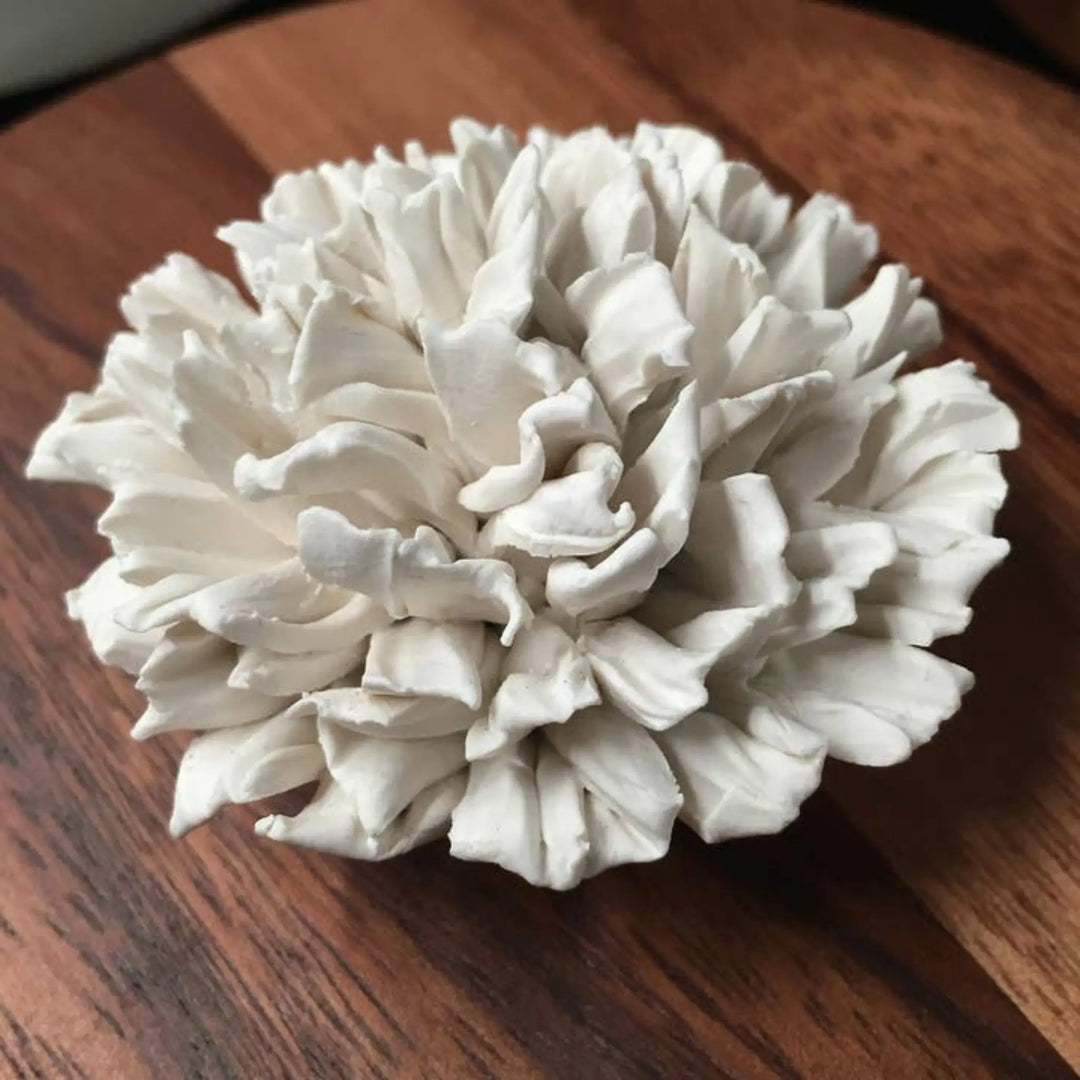 This handcrafted decorative box, made from natural Acacia wood and topped with a beautifully sculpted porcelain carnation flower,