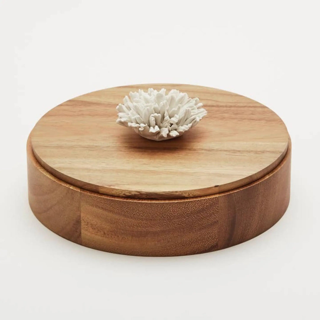 This handcrafted decorative box, made from natural Acacia wood and topped with a beautifully sculpted porcelain carnation flower,