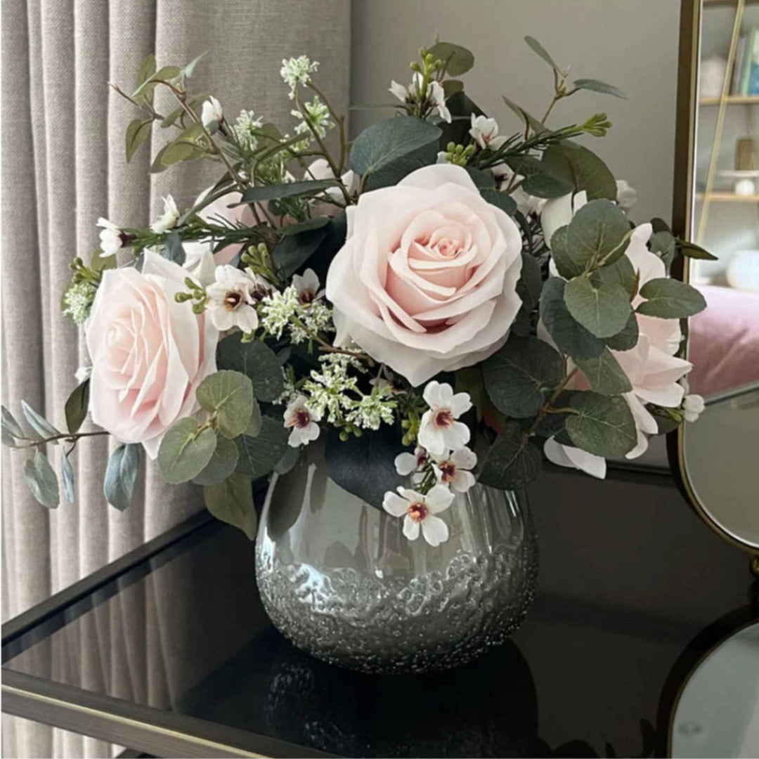 Eucalyptus, Roses and Waxflower in a Smokey Vase small