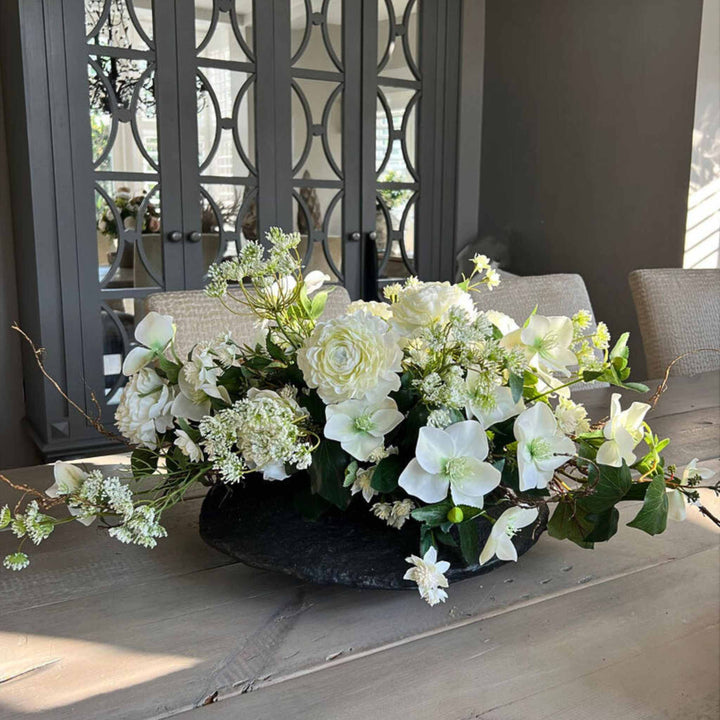 Ranunculus, Hellebore and Queen's Lace in black vase