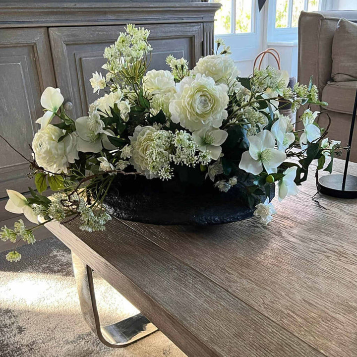 Ranunculus, Hellebore and Queen's Lace in black vase