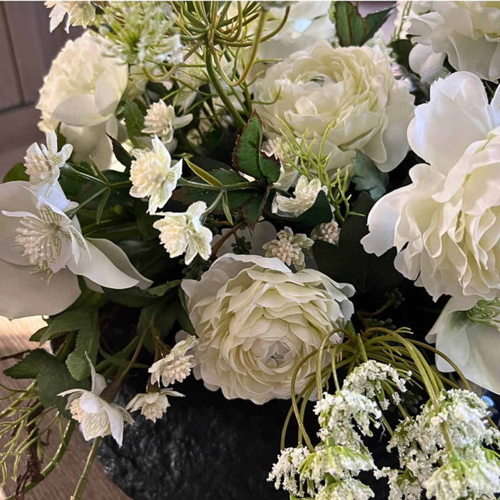 Ranunculus, Hellebore and Queen's Lace in black vase